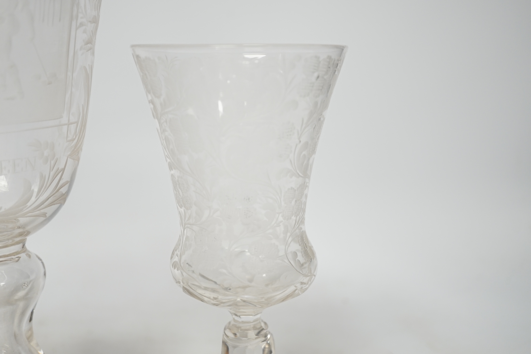 An 18th century sweetmeat glass, a 19th century large wheel engraved ‘Gretna Green’ goblet and a similar floral engraved glass, tallest 23cm. Condition good